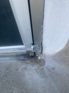 Rusted bottom door pivot needs to be replaced by a commercial door repair company